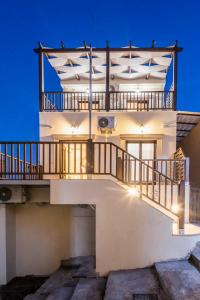 a large white house with a balcony at Fortezza Side Suite in Rethymno Town