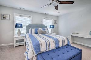 a bedroom with a blue bed and a ceiling fan at Old Town Walkable Paradise with Private Patio! in Alexandria