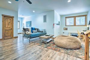 a living room with a blue couch and a table at Ronald Home with Direct Cle Elum Lake Access! in Ronald