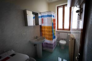 a bathroom with a sink and a toilet at Alloggio nel centro storico in Frabosa Soprana