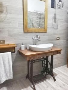 a bathroom with a sink and a mirror at Casa vacanza Flora in Grottazzolina