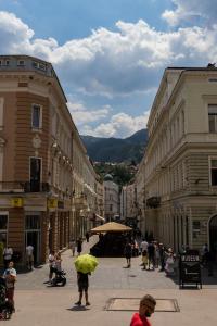 a group of people walking down a city street at Lux City Apartments & Rooms in Sarajevo