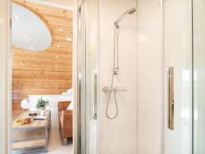 a shower with a glass door in a bathroom at Low Longlands in Cartmel +42 photos