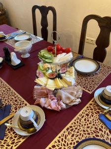 a table with a plate of food on it at Goldene Wachau - Privatzimmer in Aggsbach