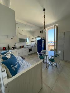 a kitchen with a bed and a table in a room at Casa Libera in Savelletri di Fasano