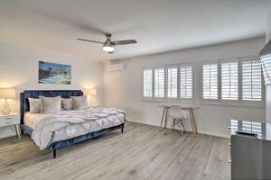 a bedroom with a bed and a ceiling fan at Modern Palm Springs Townhome Near Golf Courses in Palm Springs +27 photos