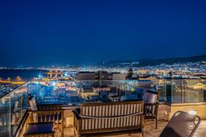 a view of a city from a balcony at night at Fortezza Side Suite in Rethymno