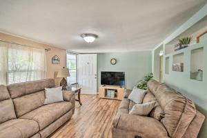 a living room with two couches and a tv at Peaceful Satsuma Escape with Dunns Creek Access in Satsuma