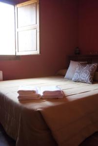 a bedroom with a large bed with a window at Hotel Rural Barranc De L'ínfern in Vall de Ebo