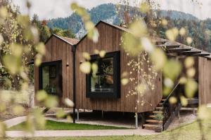 a wooden cabin with a window in a forest at Naturhotel Schütterbad in Unken +45 photos