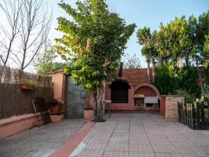 una casa con un albero e un vialetto di mattoni di LA CASA DE ROSA a Teruel