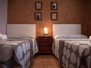 two beds sitting next to each other in a bedroom at LA CASA DE ROSA in Teruel +42 photos