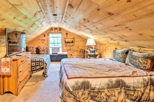 a log cabin bedroom with two beds and a television at Secluded and Quiet Pocono Mountain Cabin with Hot Tub! in Kunkletown