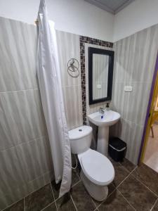 a bathroom with a toilet and a sink at Casa de Luna in La Dorada