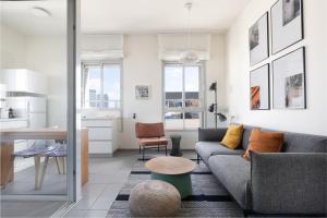 a living room with a couch and a table at Bauhaus Boutique by TLV2rent in Tel Aviv