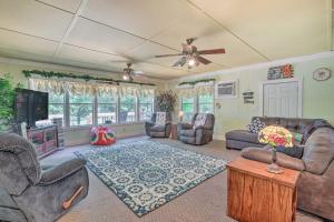 a living room with couches and a flat screen tv at Waterfront Sparta Gem with Fire Pit and Kayak! in Sparta