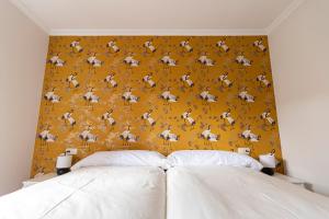 a bedroom with a yellow wall with horses on it at Casa das Regueiras in Santiago de Compostela