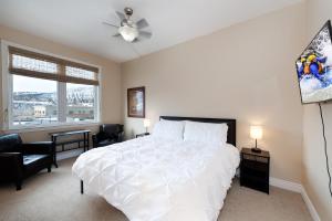 a bedroom with a large white bed and a window at Mears House Unit 3C in Durango