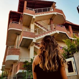 a woman standing in front of a building at Vila Anxhelo in Vlorë