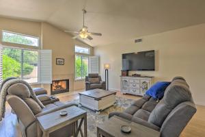 a living room with two couches and a flat screen tv at Saddlebrooke Home with Private Pool and Amenities in Catalina