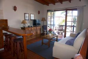 a living room with a couch and a table at Finca La Romera in La Orotava