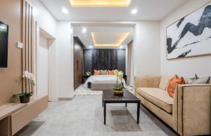 a living room with a couch and a bed at Sapphire Heights Apartment Single Rooms in Lagos