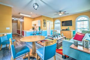 a living room with a couch and a table and chairs at Colorful Myrtle Beach Golf Club Condo with Pool in Myrtle Beach