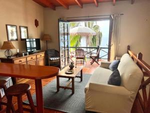 a living room with a couch and a table at Finca La Romera in La Orotava