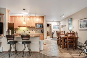 a kitchen and dining room with a table and chairs at Copper Junction 305 in Frisco