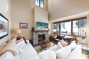 a living room with white couches and a fireplace at Purgatory Lodge Unit 507 in Durango Mountain Resort