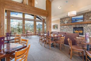 a restaurant with tables and chairs and a fireplace at Purgatory Lodge Unit 507 in Durango Mountain Resort