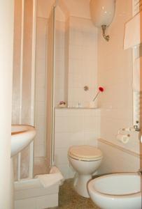 a white bathroom with a toilet and a sink at Residence Domus in Pisa