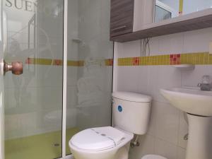 a bathroom with a toilet and a sink at Aparta-Hotel El Dorado in Aguadas