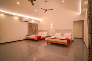 a bedroom with two beds and a ceiling at KINGS RESORT DANDELI in Dandeli