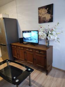 a room with a desk with a television and a refrigerator at Luka in Split