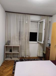 a bedroom with a large bed and a window at Luka in Split