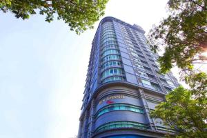 a tall blue building with a sign on it at The Rixx Premium Apartment (gym/pool/security) in Ho Chi Minh City