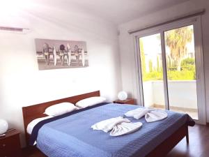Un dormitorio con una cama azul con toallas. en Villa14 Sea Breeze, en Klorakas