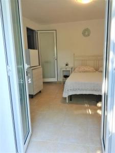 a bedroom with a bed and a door to a room at Lucrae' in Finale Ligure