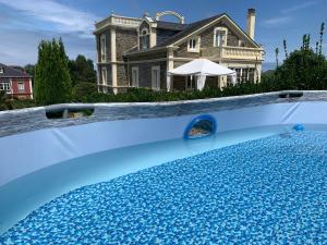 a house with a swimming pool in front of a house at Villa Auristela in Navia +54 photos