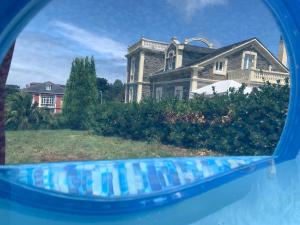 a reflection of a house in a rear view mirror at Villa Auristela in Navia