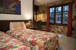 Säng eller sängar i ett rum på Posada Del Fin Del Mundo