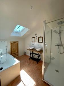 a bathroom with two sinks and a glass shower at Château le Fresne in Bouchemaine