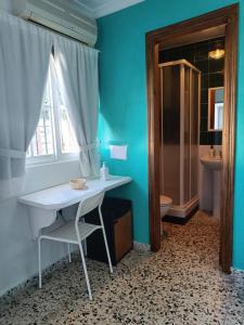 a bathroom with a white table and a toilet at Alojamientos La Menúa in Los Badalejos
