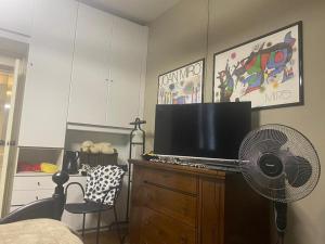 a living room with a television and a fan at Bice house in Terni