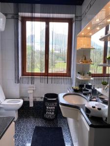 a bathroom with a tub and a toilet and a sink at Bice house in Terni