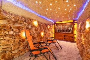 two chairs in a room with a stone wall at Bulwar Residence & Wellness in Kazimierz Dolny