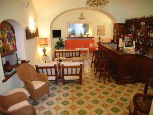a bar in a restaurant with chairs and tables at Hotel Europa in Ischia