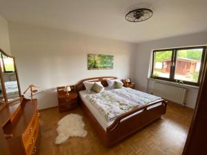 a bedroom with a bed with a rug on the floor at Idyllisches Ferienhaus “Werra Ausblick” am Meißner in Hitzerode