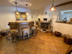 a kitchen with a bar and stools in a room at Idyllisches Ferienhaus “Werra Ausblick” am Meißner in Hitzerode